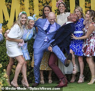 Mike Tindall, 44, took center stage in a Magic Millions race day group photo as he raised his leg for a friend to carry.