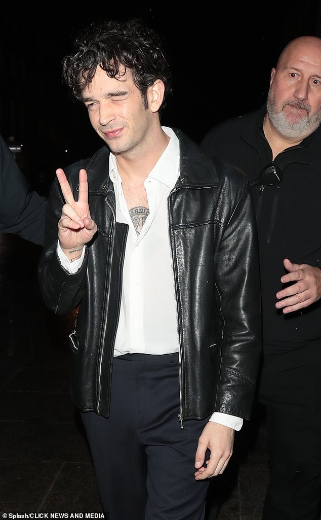 Worse from use: The singer, 33, flashed a teary-eyed screen as he squinted and flashed the peace sign as he left the party at London's The Standard Hotel in the early hours