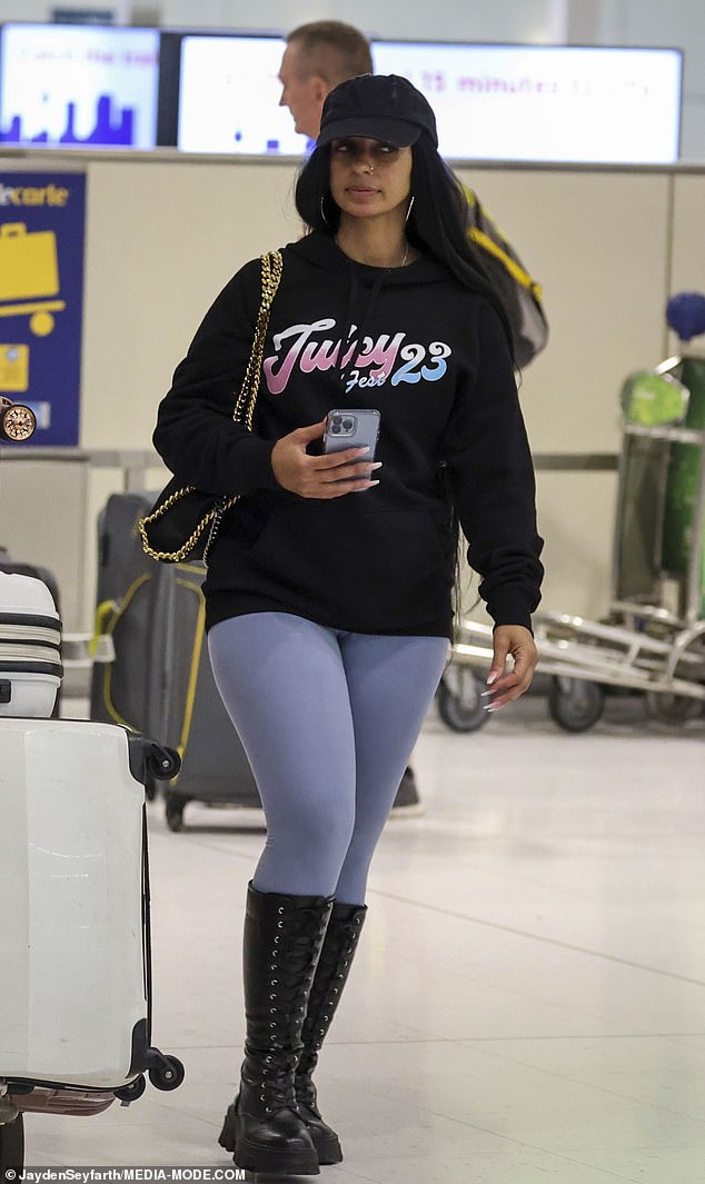 Case Former star Mya, 43, kept her look chic for the flight in a slouchy 'Juicy 23' sweater along with sky blue tights