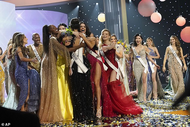 Gabriel is hugged by his fellow competitors after winning the Miss Universe crown on Saturday