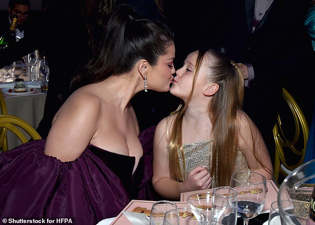 Cute: Selena sweetly kissed her younger sister Gracie at the Golden Globes on Tuesday, after missing out on Best Actress on Television - Musical/Comedy Series gong