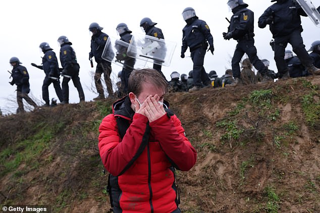 There have been violent clashes between protesters and police at the mine in recent days.  Image: A protester holds his eye at a rally yesterday