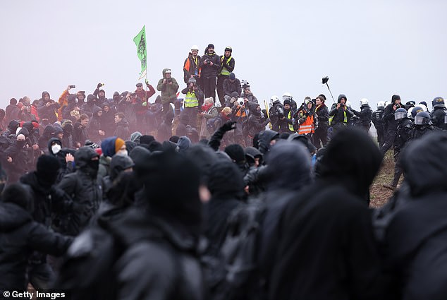 Protesters gather outside the coal mine as they prepare to confront police on Saturday, January 14.