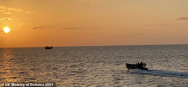 A suspicious dhow is approached by one of HMS Montrose's boats filled with a team of Royal Marines