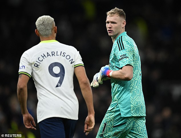 The Arsenal goalkeeper (right) was quick to celebrate after the final whistle and threw a punch into the air in front of Tottenham striker Richarlison (left)