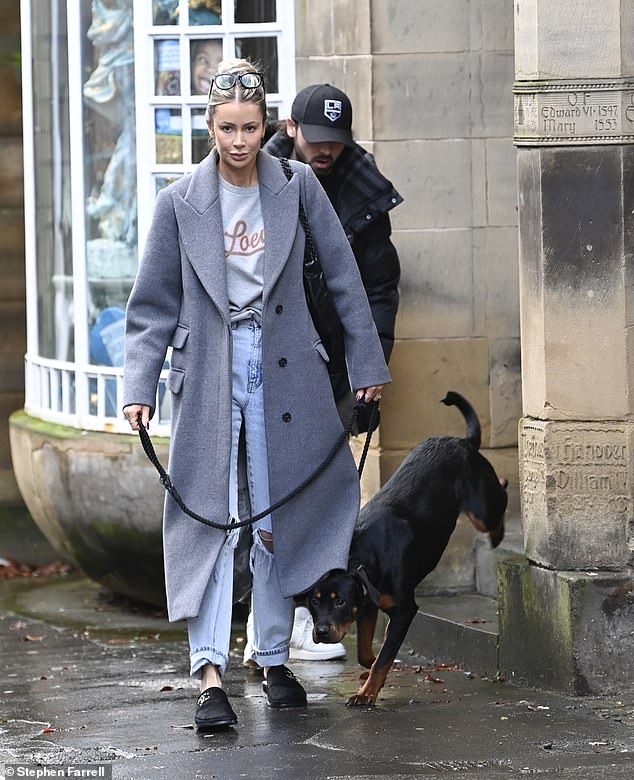 Behind the Pack: Footballer Bradley follows his fiancée Olivia and excitable pup Stitch.