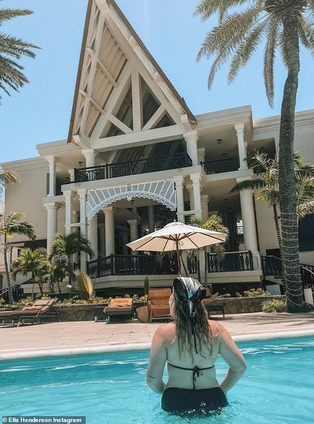 Soaking up the sun: The former X Factor star looked amazing as she cooled off with a swim in a black bikini and swept her long, naturally wavy locks back with a headscarf