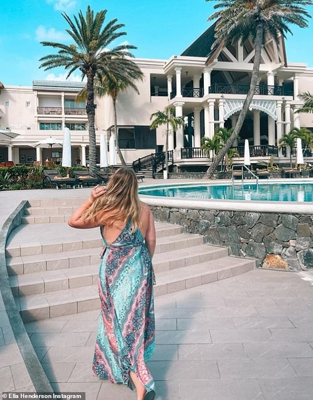 Stylish: The Ghost singer was seen strolling around the idyllic resort in a blue and pink print maxi sundress in another photo