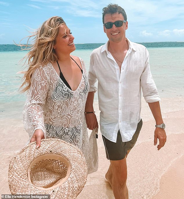 Bliss: Another image from her Christmas album showed them enjoying a romantic walk on the beach holding hands, where Ella was wearing a black bikini and a white patterned dress.