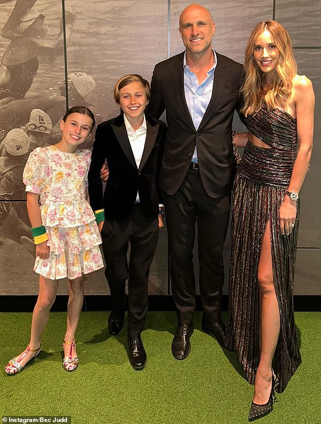 Bec (pictured with her husband Chris and their two oldest children, Billie and Oscar) opened up about her fitness routine in the past, saying she loves to play cardio tennis.