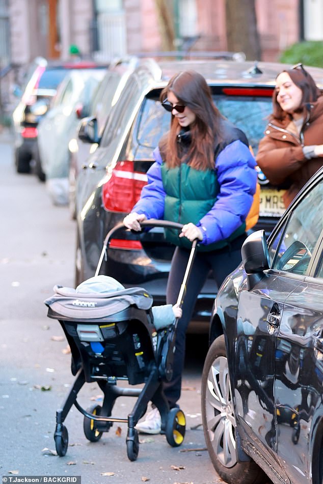 Stylish: The 31-year-old supermodel, recently divorced, bundled up in a color-blocked North Face coat as she pushed the nearly two-year-old in a stroller