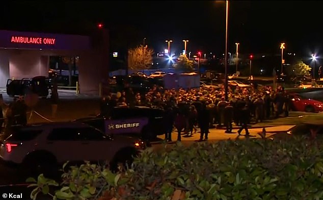 Officers are seen standing outside the Inland Valley Medical Center where Deputy Calhoun died