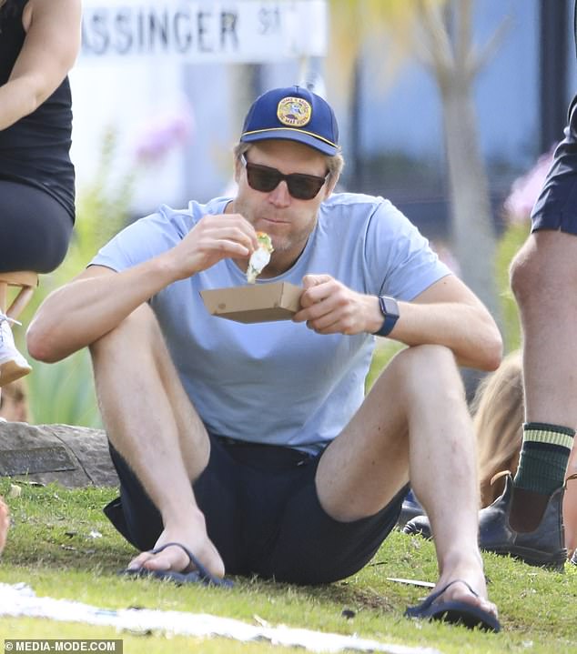 Chris was also seen sitting on the grass and enjoying a meal after his fun day at the beach.