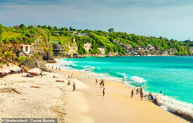 The once-pristine beach is a hotspot for tourists who flock to the destination to soak up the sun and enjoy the party atmosphere (Pictured: Kuta Beach, Bali)