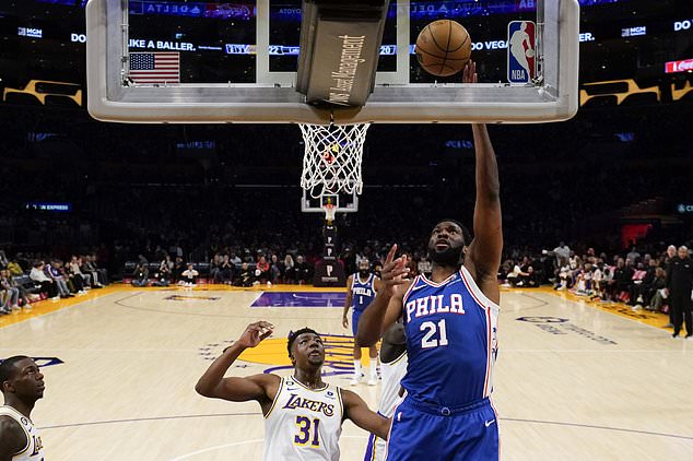 Philadelphia 76ers center Joel Embiid shoots at Los Angeles center Thomas Bryant.