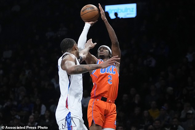 Oklahoma City Thunder's Shai Gilgeous-Alexander (2) shoots over Brooklyn Nets' Nic Claxton