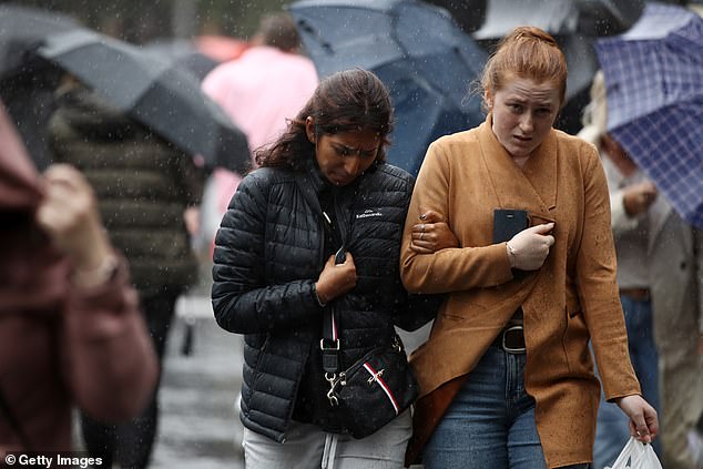 Pedestrians brave rain and cold weather in Sydney's CBD on January 6, 2023