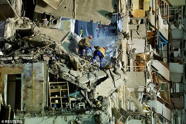 Emergency personnel work at the site of an apartment block that was badly damaged by a Russian missile attack in Dnipro, Ukraine, on January 15.