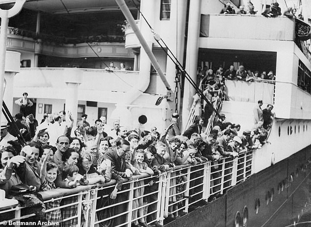 A crowd of German Jewish refugees aboard the ocean liner MS St. Louis wave as they arrive in Antwerp, Belgium, after wandering the Atlantic for thousands of miles.