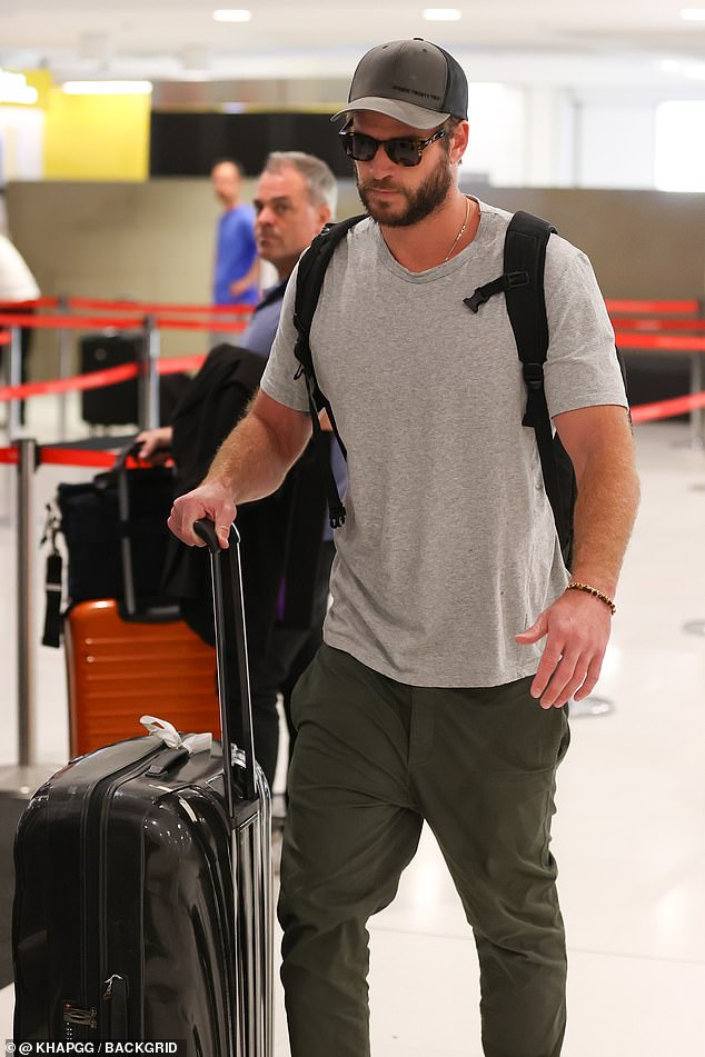 Liam tried to go undercover in a baseball cap and oversized sunglasses as he made his way to the terminal.