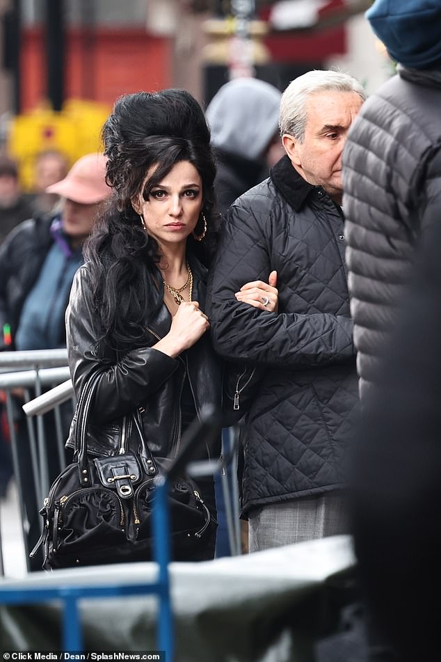 Signature Look: The actress carried a leather handbag and sported Amy's signature hairstyle and gold hoop earrings.