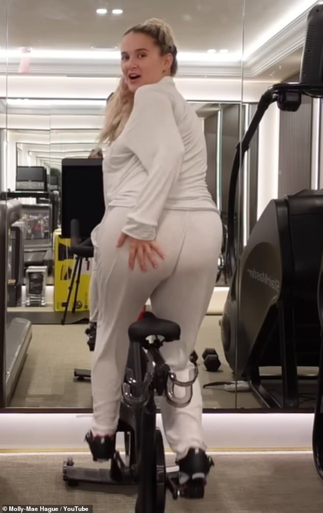 Watchable: Elsewhere, the mom-to-be worked up a sweat on an exercise bike in her home gym and, while being filmed from behind, told viewers: 