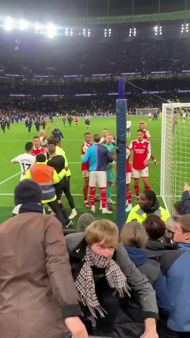 The fan can then be seen climbing towards his seat with a scarf pulled over his face.