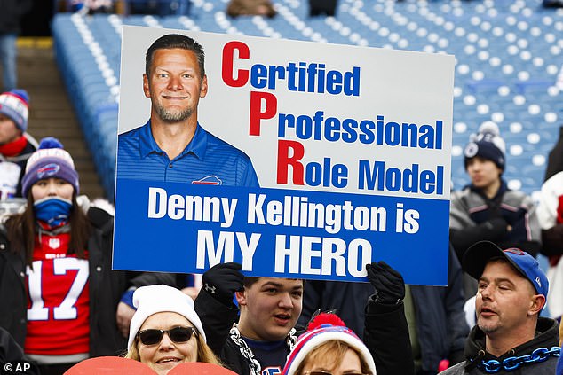 A fan holds a sign with Buffalo Bills coach Denny Kellington during practice before an NFL game on January 8.