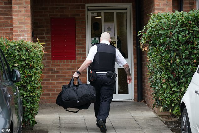 A police officer entered the scene at Clariat Court in Boddington Gardens, Acton.