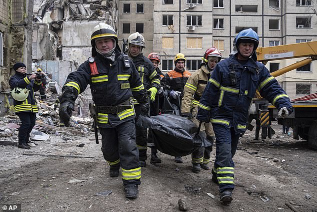 Rescue teams carry the body of a man who was killed in a Russian missile attack on Saturday.