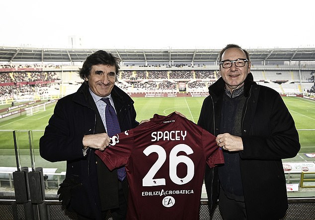 Spacey has been photographed making the most of Italy.  He was in the stands to watch Torino FC take on Spezia Calcio at the Stadio Olimpico di Torino on Sunday, where club president Urbano Cairo (left) presented him with a Torino FC football shirt with his name on the back.