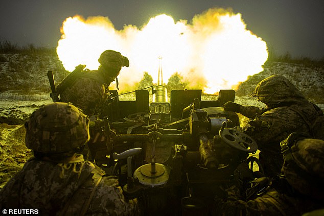 Ukrainian servicemen fire an anti-aircraft gun at Russian positions on a front line near the town of Bakhmut, amid Russia's attack on Ukraine, in the Donetsk region on Sunday.