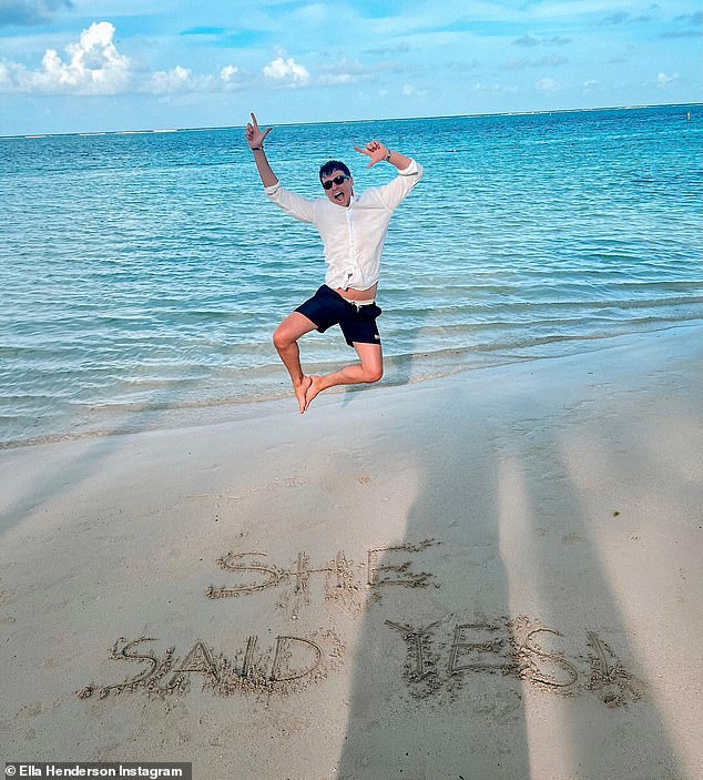 Cute: Another snapshot showed Jack jumping for joy on the beach with the words 'she said yes!'  written in the sand in front of him