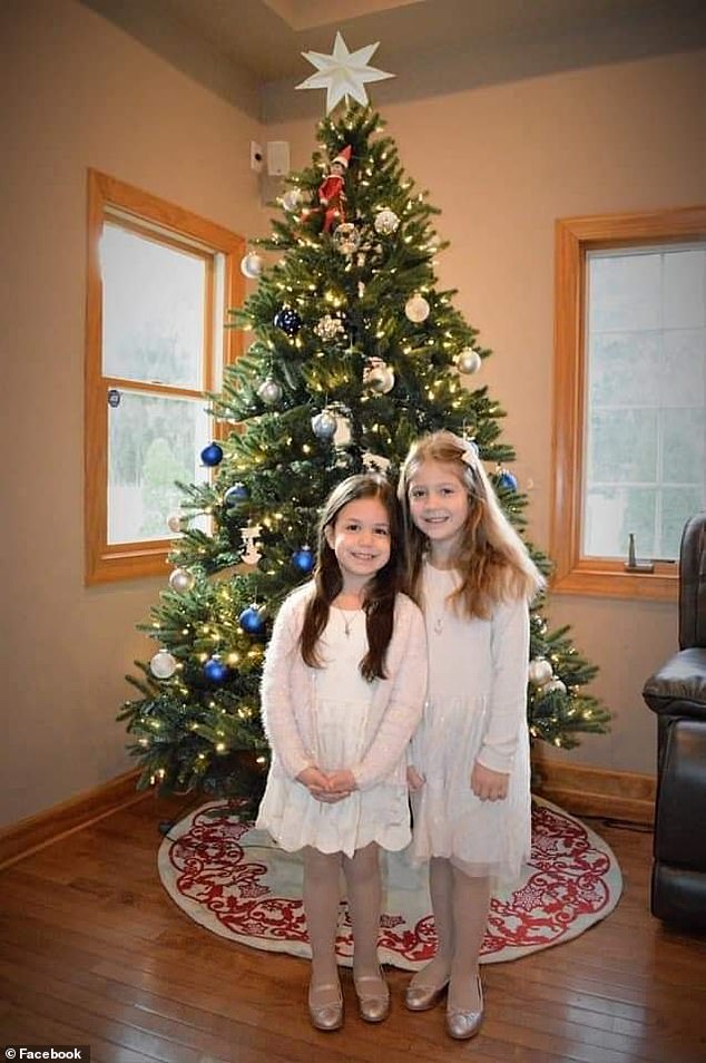 Madelyn (left) and Elena (right) posed in front of a Christmas tree.