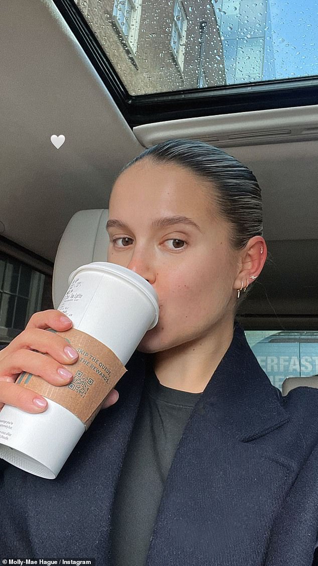 Radiant: The glowing mum-to-be went makeup-free for her outing in Manchester, where she grabbed a takeaway coffee