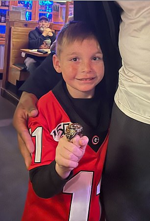 The young fan was photographed trying on the size of Willock's championship ring.