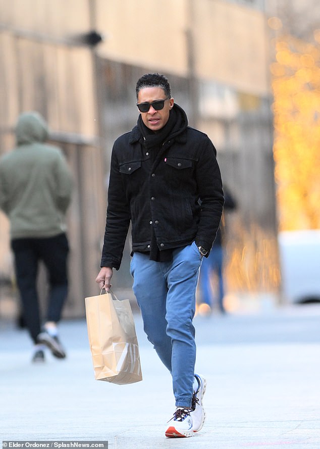 Homes wears a pair of white sneakers as she strolls down a sidewalk in New York City.