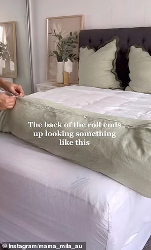 He pushed the entire rolled quilt through the opening at the bottom of the cover.