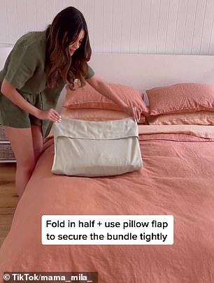 She pushed the pieces to the other end of the pillowcase and folded it in half, using the pillow's flap to secure the bulge firmly.