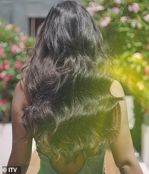 Stunning: Her raven tresses let loose into a brushed curl as she entered the villa.