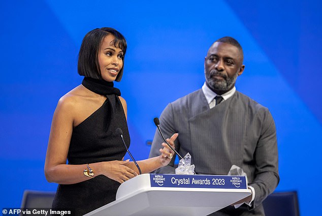 Couple: The actress, 32, was the picture of elegance in a black asymmetrical dress as she was joined by her husband Idris, 50, who looked suave in a gray double-breasted suit