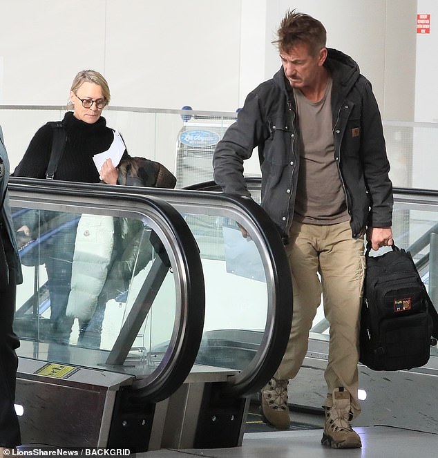 Wheels up: The exes were dressed casually while holding their luggage