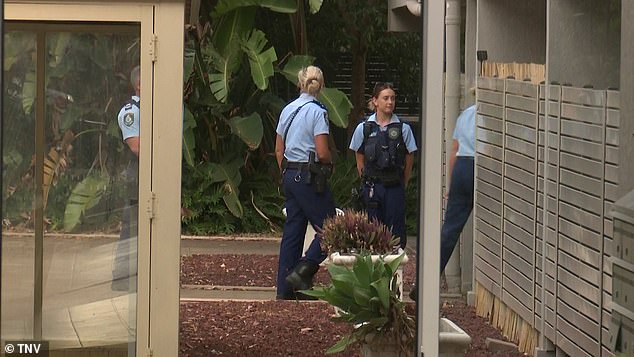 Specialized forensic police examine the house and what remains of the vehicle