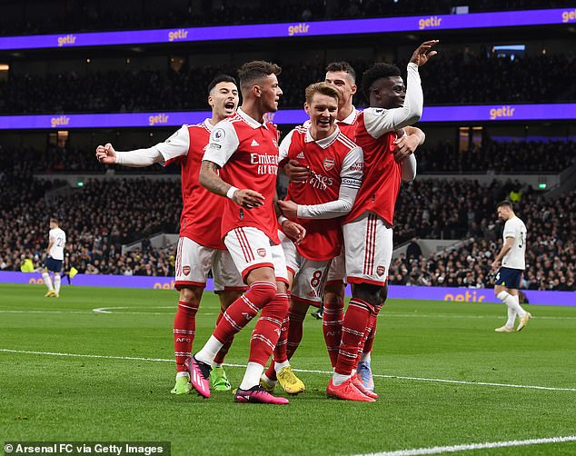 Arsenal players celebrate the first goal of the derby against Tottenham Hotspur