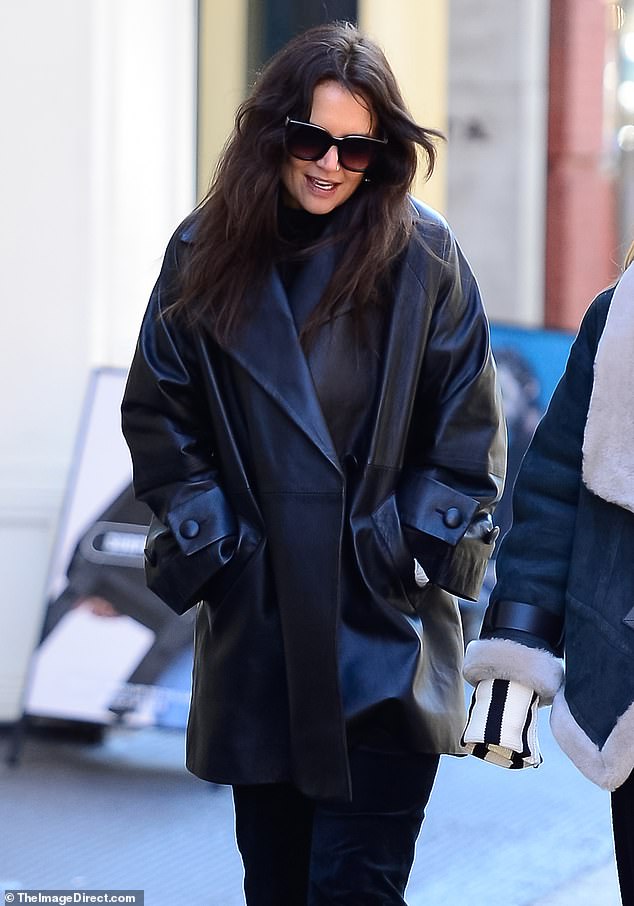 Windswept: The Toledo, Ohio native's long dark locks looked windswept and she appeared to be wearing minimal makeup  She completed the look with large dark sunglasses and gold hoop earrings.