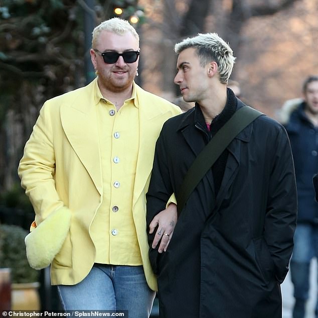 Stylish: The singer, 30, always looked on-trend in a must-have yellow shirt under a matching blazer with fluffy cuffs