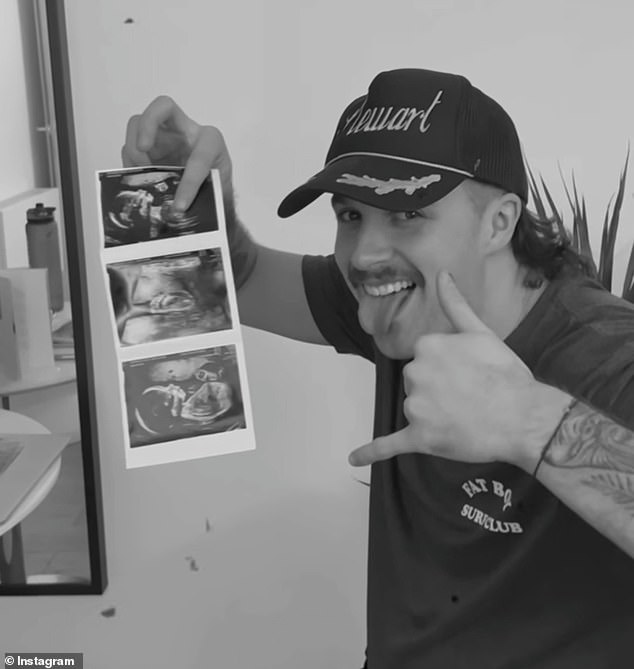 Proud to be a dad!  In the clip, Liam is seen holding the ultrasound image of the baby.