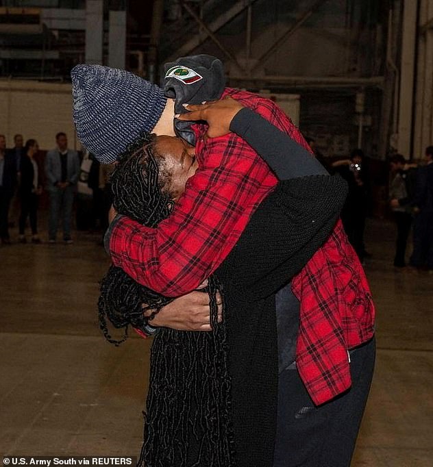 Cherelle Griner, 30, held his wife, 32, close after she stepped off the plane in San Antonio after 294 days apart.