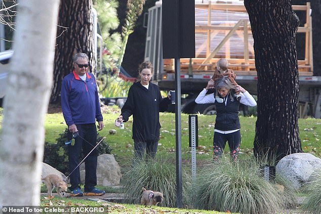 Family outing: The Causeway actress was spotted getting some fresh air alongside her parents and some adorable pups