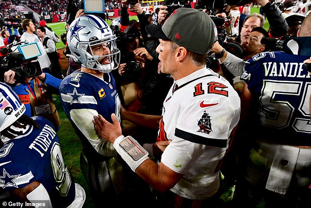 Dak Prescott #4 of the Cowboys and Tom Brady #12 of the Buccaneers embrace on the field after their play in the NFC Wild Card playoff game at Raymond James Stadium